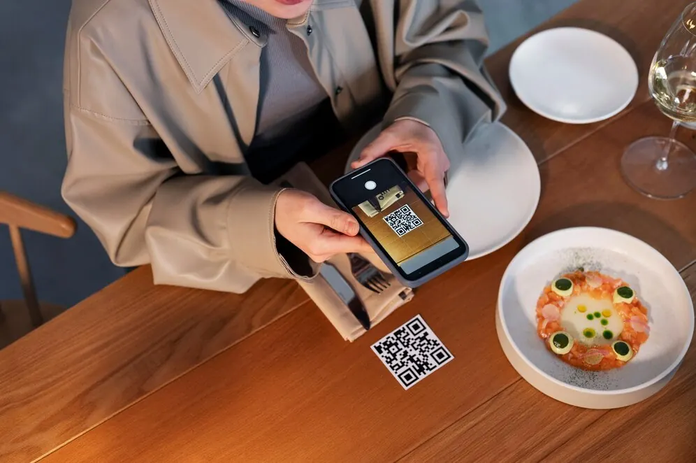 Diner scanning a QR code at their table to open the menu
